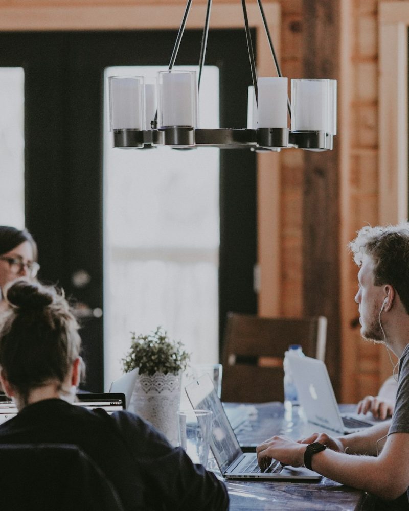 Client team meeting around a table in a bright office